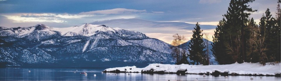 Snow-covered mountains under a cloudy sky.